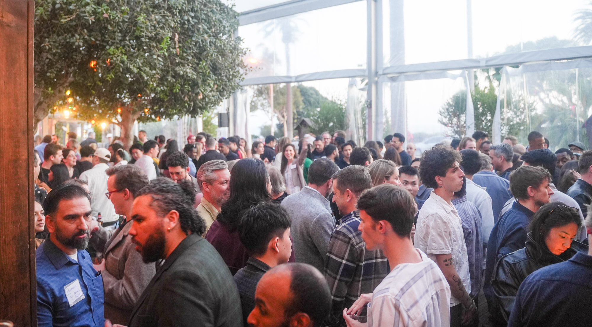 Attendees standing around high-top tables