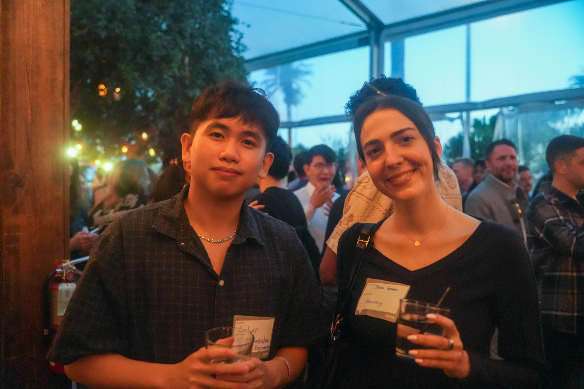 Three people talking near the bar