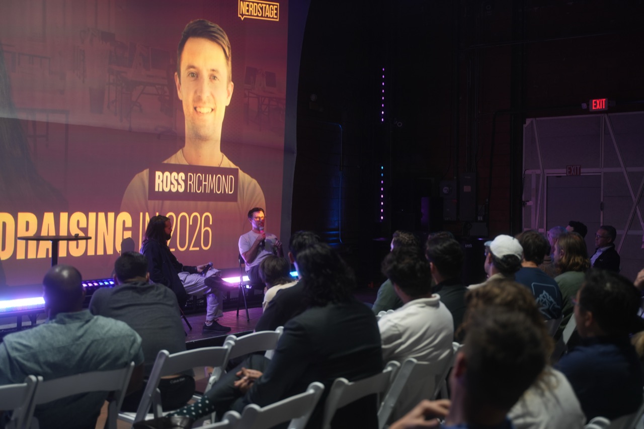 Alternate angle of the fireside chat with Ross Richmond's headshot projected behind