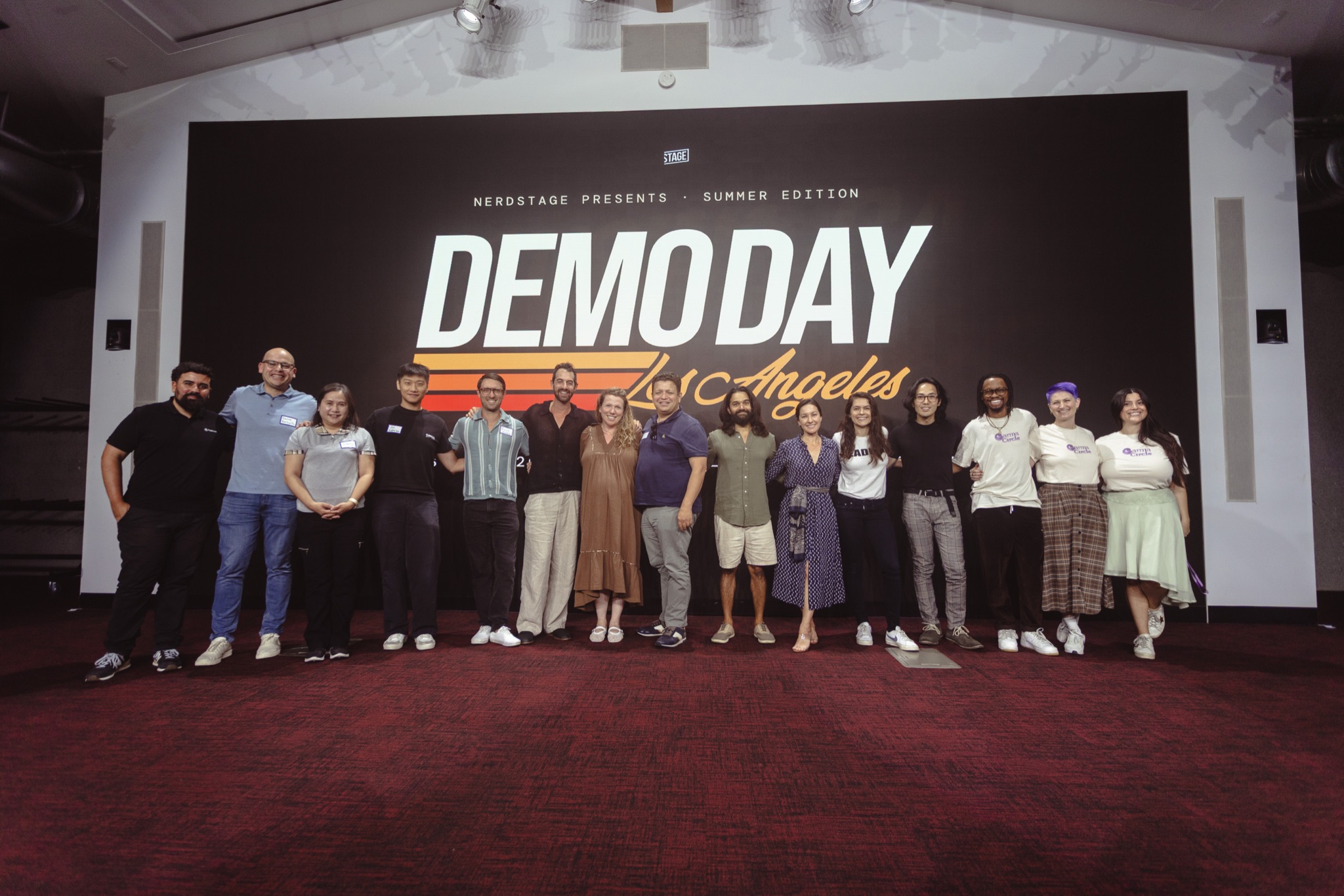 The August cohort and Nerdstage team on stage under the Demo Day Los Angeles marquee