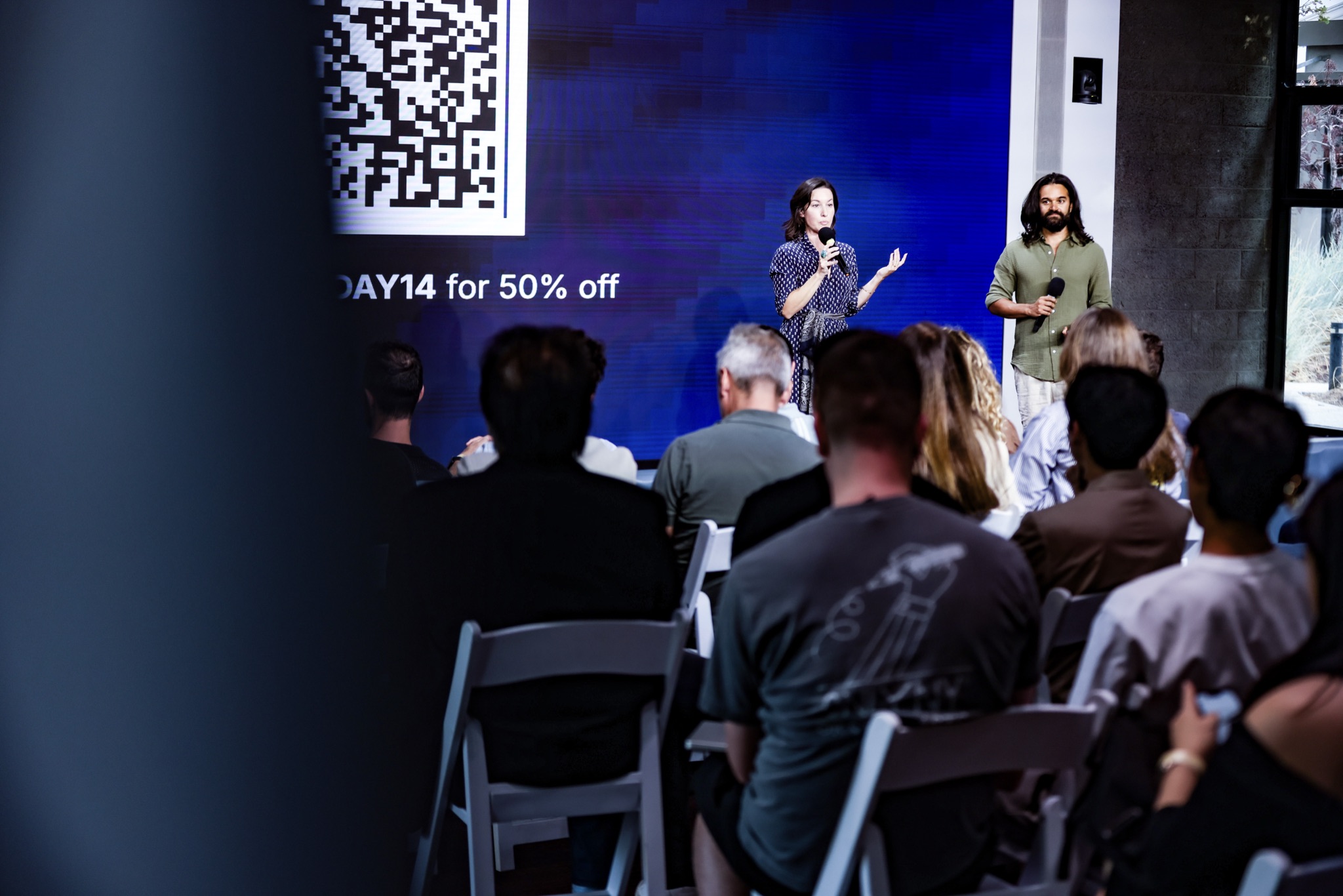 The hosts on stage between pitch sessions
